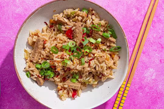 Teriyaki style Quorn Vegetarian Steak Strips with egg fried rice in a bowl with chopsticks