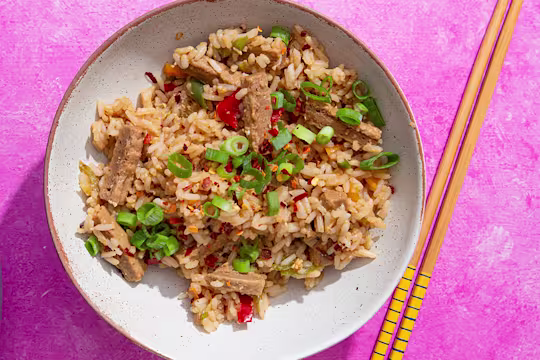 Teriyaki style Quorn Vegetarian Steak Strips with egg fried rice in a bowl with chopsticks