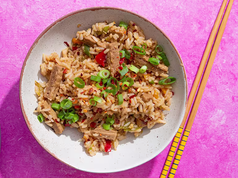 Teriyaki style Quorn Vegetarian Steak Strips with egg fried rice in a bowl with chopsticks