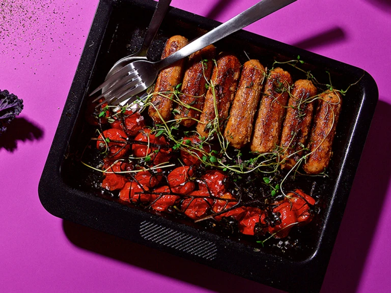 A hot dog platter made with Quorn Sausages, mustard, and gherkins in a shallow Dutch oven.