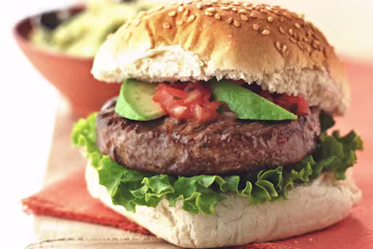 Quorn Veggie Burger, made with Quorn Quarter Pounders, and served in a bun with avocado, tomato, onion and lettuce