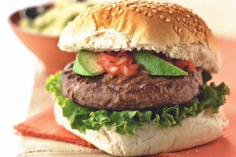 Quorn Veggie Burger, made with Quorn Quarter Pounders, and served in a bun with avocado, tomato, onion and lettuce