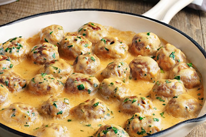 Creamy Swedish meatballs presented in a white oven dish