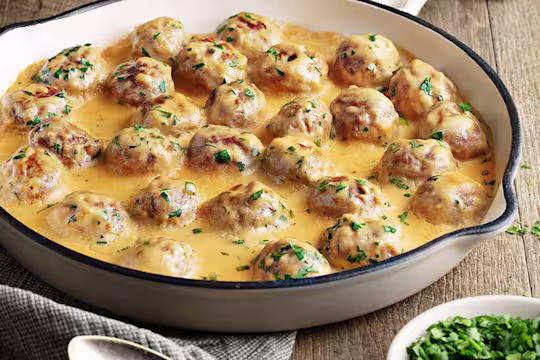Creamy Swedish meatballs presented in a white oven dish