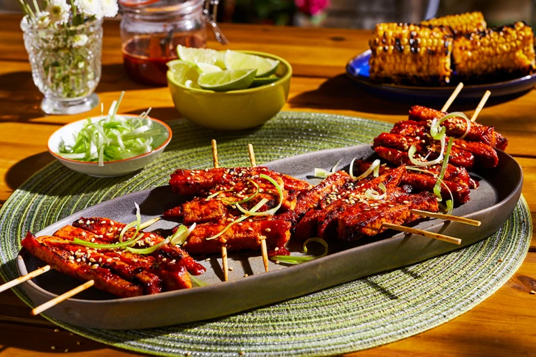  platter with four servings of Korean BBQ Skewers made with Quorn Vegan Meatless Fillets topped with sesame and scallions.