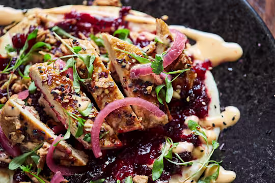 Flatbreads layered with beetroot chutney, Quorn Fillets, sliced, topped with picked onions and herbs and Sriracha mayonnaise