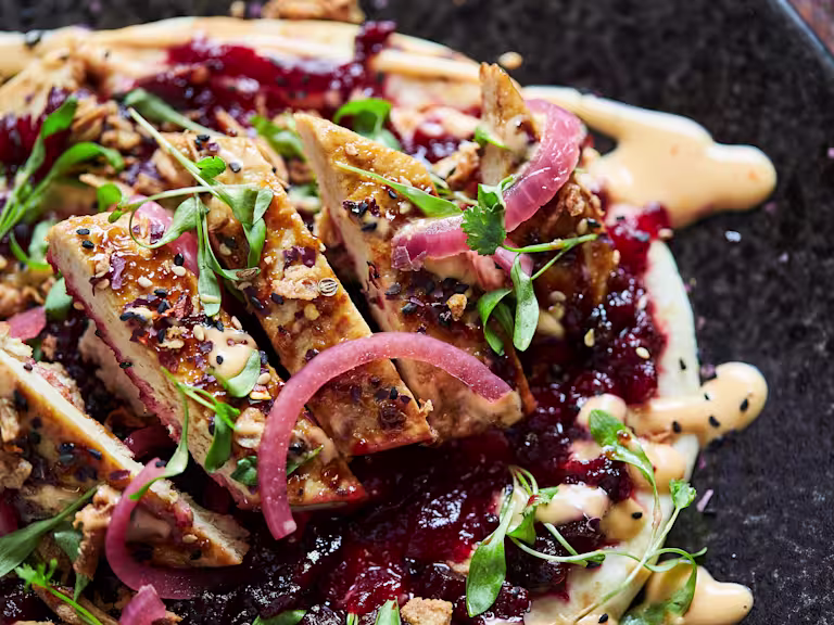 Flatbreads layered with beetroot chutney, Quorn Fillets, sliced, topped with picked onions and herbs and Sriracha mayonnaise