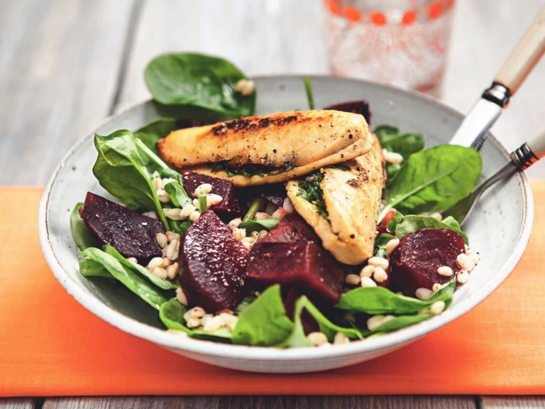 A spinach and bulgur wheat salad topped with beets and Quorn Fillets stuffed with herbs.