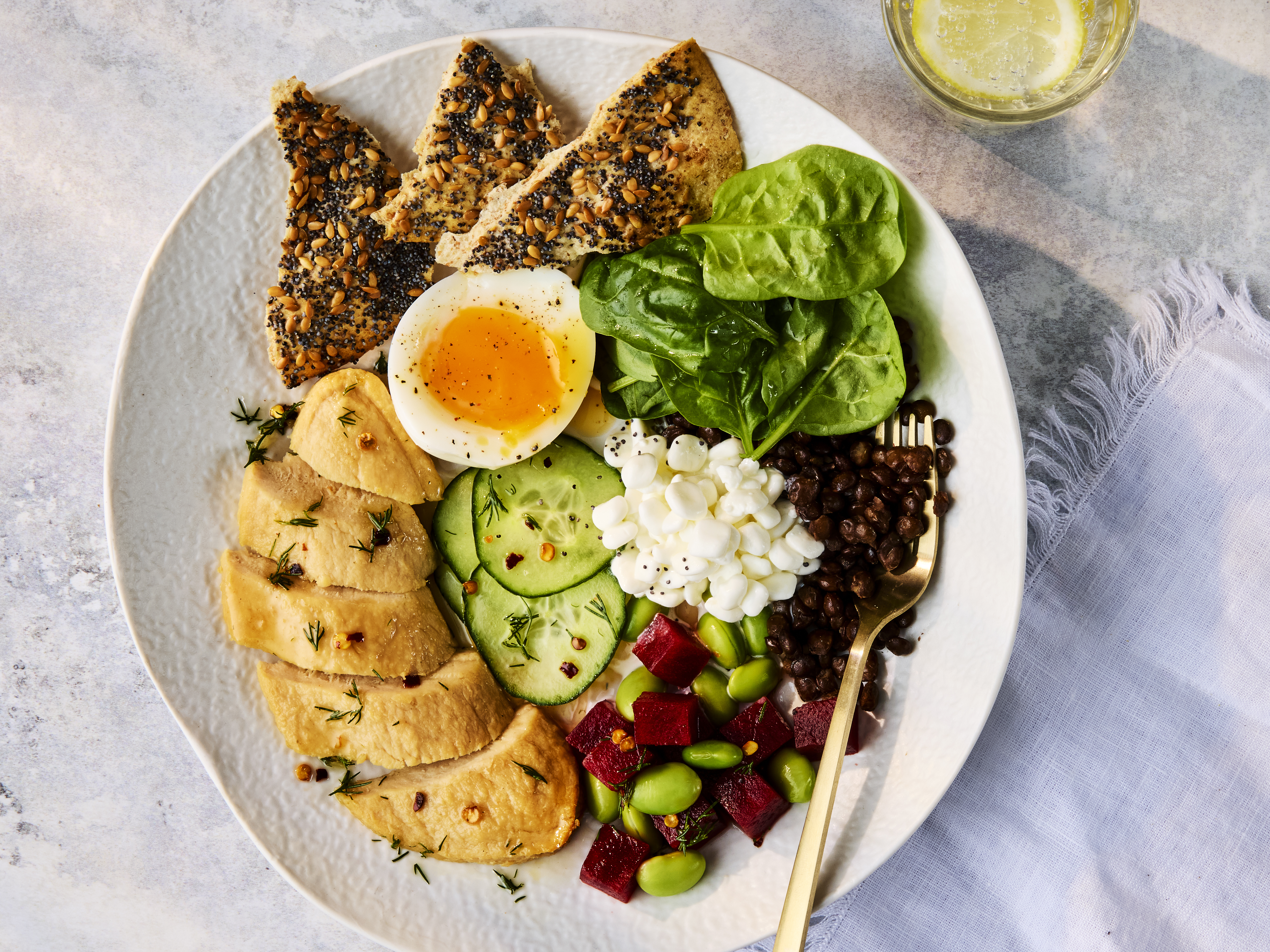 Plated Scandi Protein Bowl with Quorn Fillets, a soft-boiled egg, cottage cheese, and mixed fresh vegetables.