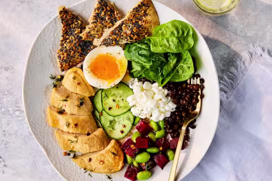 Plated Scandi Protein Bowl with Quorn Fillets, a soft-boiled egg, cottage cheese, and mixed fresh vegetables.