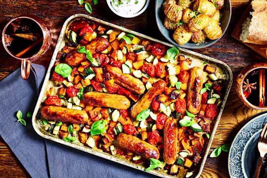 A traybake with Quorn Sausages, butternut squash, tomatoes, and courgette.