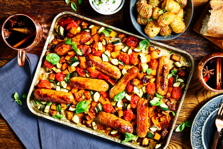 A traybake with Quorn Best of British Sausages, butternut squash, tomatoes, and courgette.