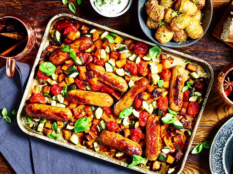 A traybake with Quorn Sausages, butternut squash, tomatoes, and courgette.