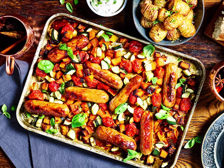 A traybake with Quorn Sausages, butternut squash, tomatoes, and courgette.