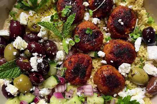 Harissa Swedish Style Balls Salad Bowl displaying Swedish Style Balls, mixed olives, feta, red onions and cucumber.