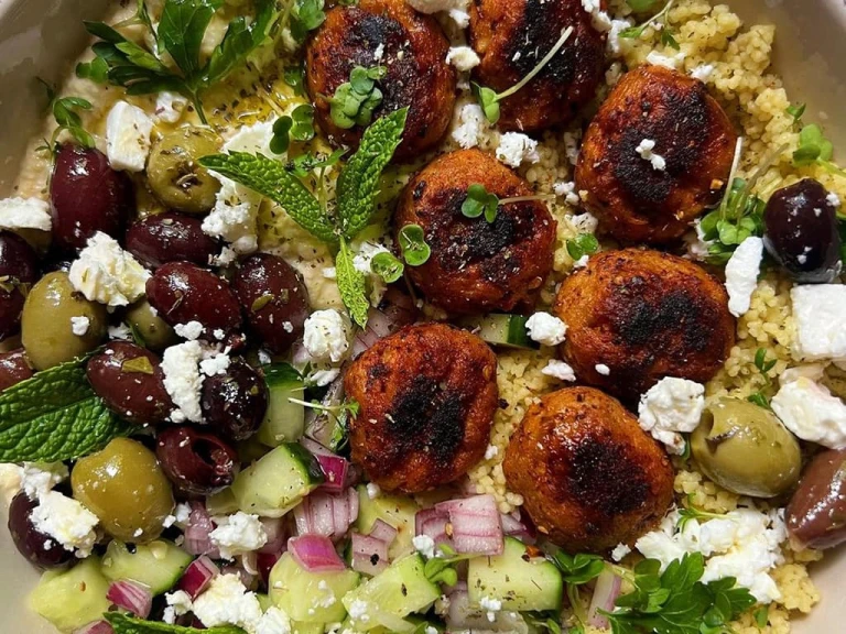 Harissa Swedish Style Balls Salad Bowl displaying Swedish Style Balls, mixed olives, feta, red onions and cucumber.