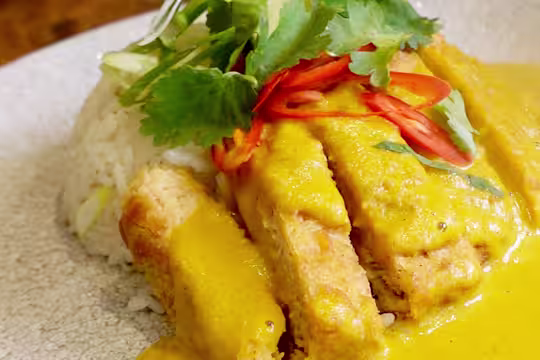 Quorn Tempura Vegetarian Fillets with Katsu Curry topped with red chillies and green garnishing