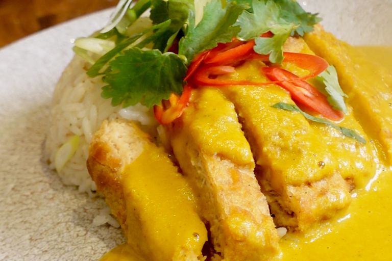 Quorn Tempura Vegetarian Fillets with Katsu Curry topped with red chillies and green garnishing
