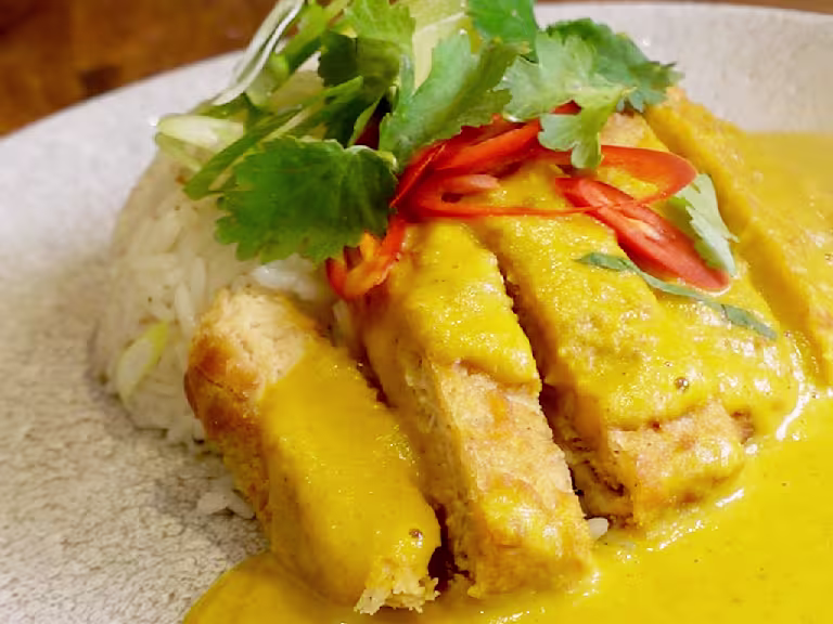 Quorn Tempura Vegetarian Fillets with Katsu Curry topped with red chillies and green garnishing