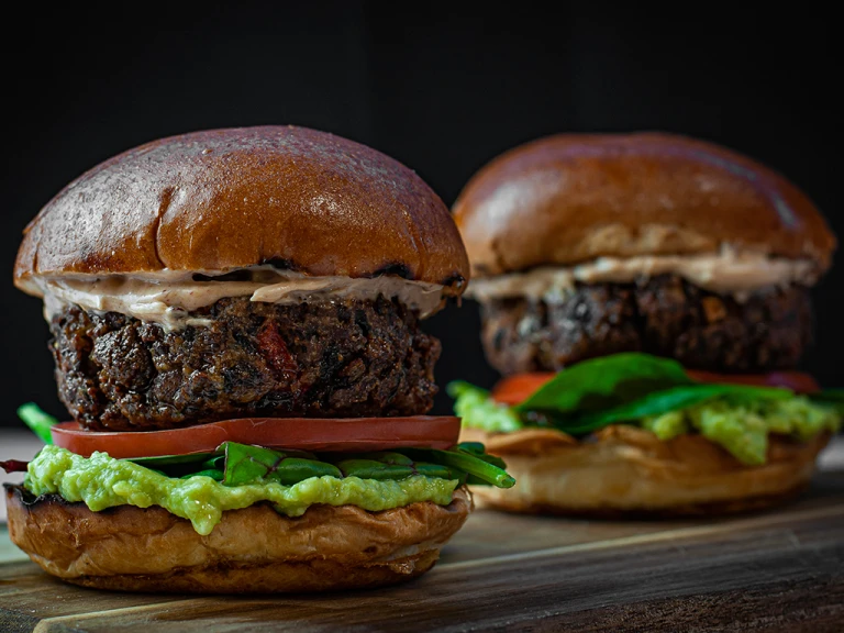 Two Chipotle black bean burgers on a table