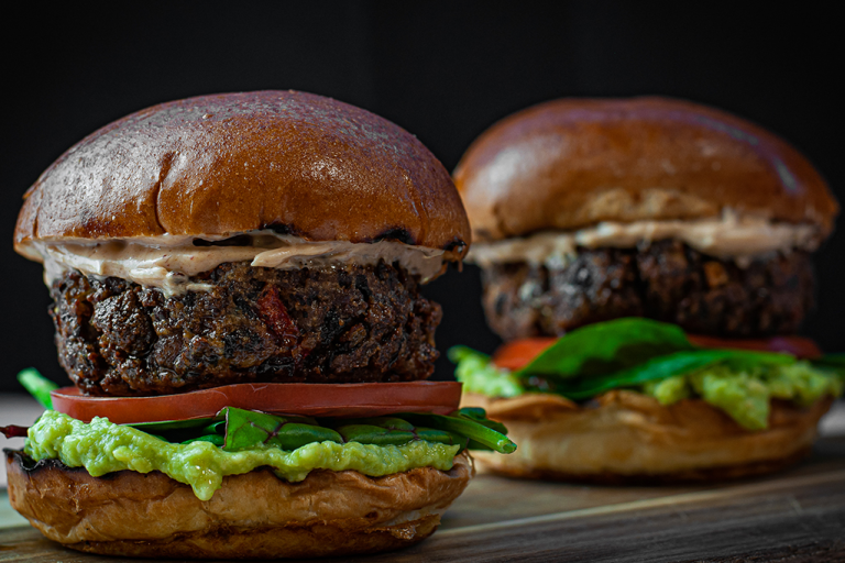 Two Chipotle black bean burgers on a table