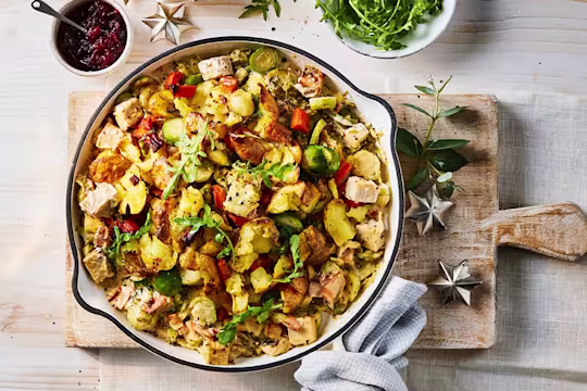 A large serving of Quorn Festive Bubble and Squeak Vegetarian Pie with a side of cranberry sauce.