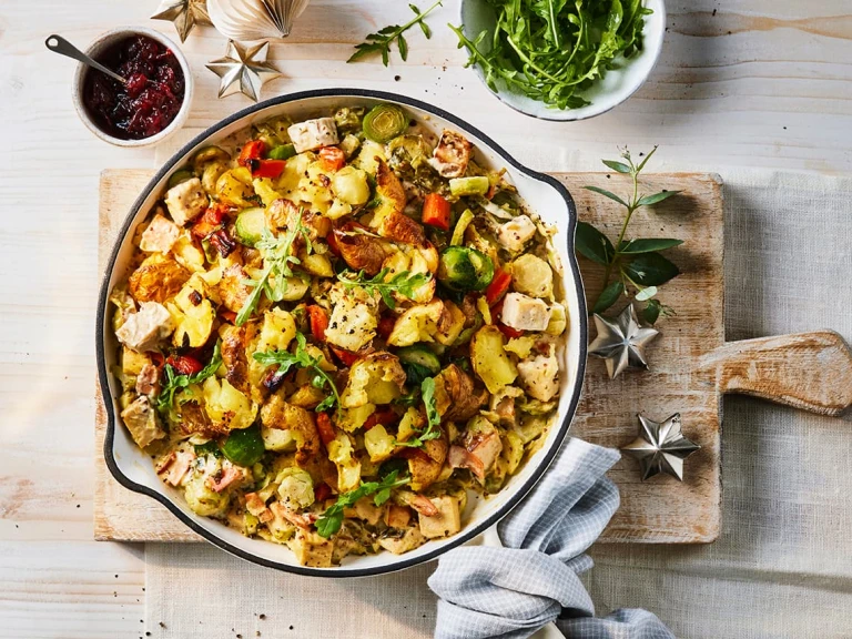 A large serving of Quorn Festive Bubble and Squeak Vegetarian Pie with a side of cranberry sauce.