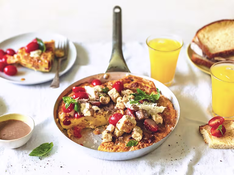 An egg frittata with Quorn Pieces, tomatoes, and mozzarella with a balsaminc cream dressing on the side.