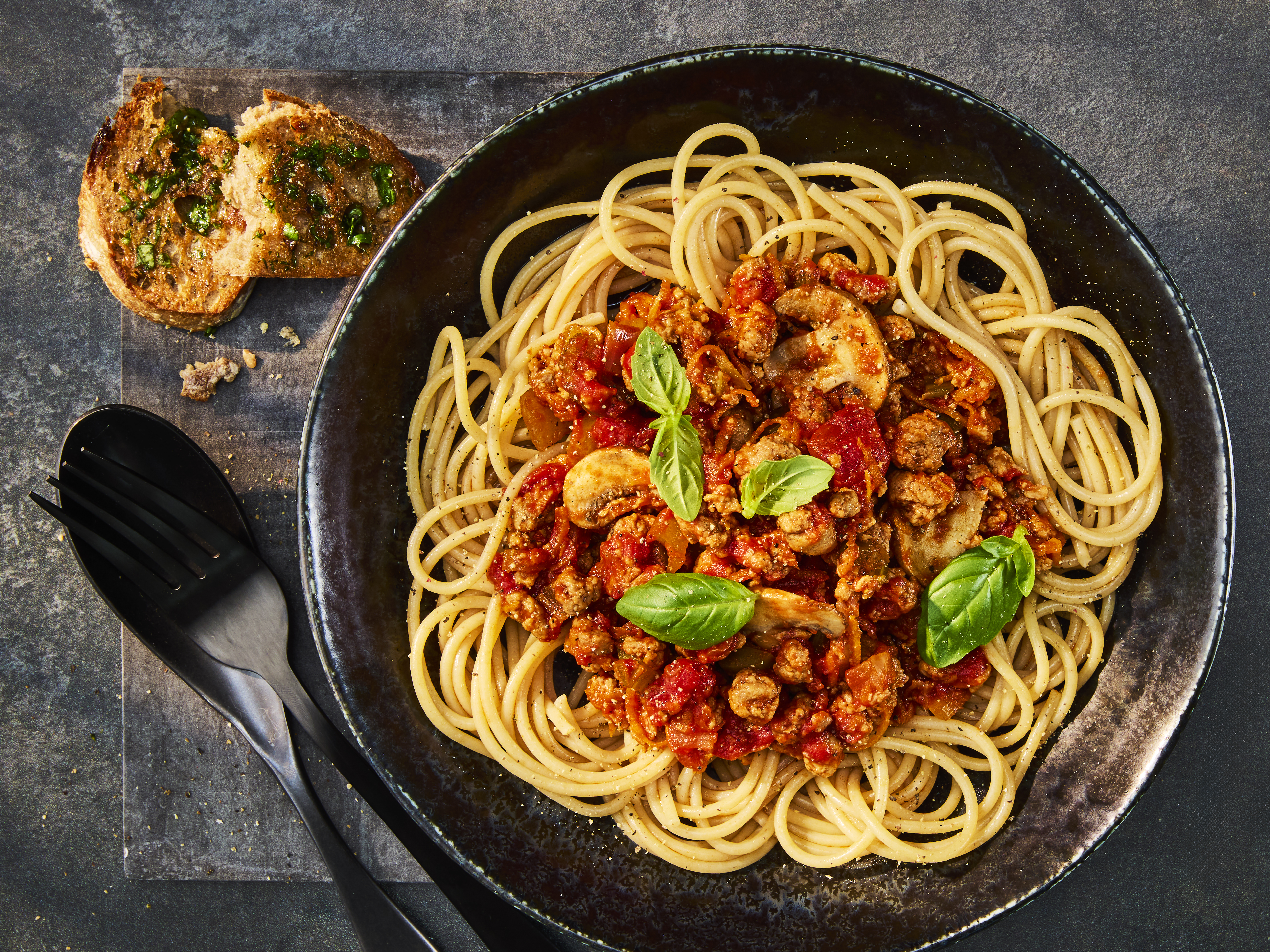 A tasty bowl of Quorn Mince Bolognaise served over Wholemeal Spaghetti and garnished with fresh basil.