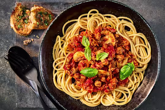 A tasty bowl of Quorn Mince Bolognaise served over Wholemeal Spaghetti and garnished with fresh basil.