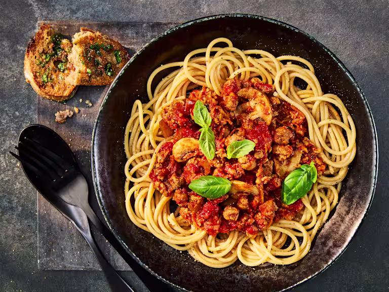 A tasty bowl of Quorn Mince Bolognaise served over Wholemeal Spaghetti and garnished with fresh basil.