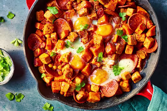 Vegetarian Hash with Quorn Pieces and Pepperoni served in a frying pan with mint leaves.