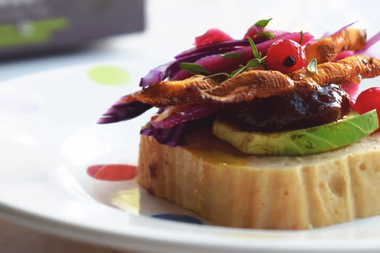 Vegetarian Christmas Canapes, made with Quorn Roast, brussel sprouts, cabbage, carrot and red currants, served on a plate.