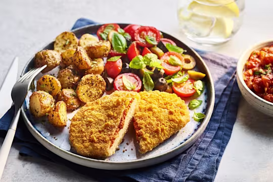 Quorn Mozzarella and Tomato Escapes with Italian potatoes and tomato and olive salad on the side