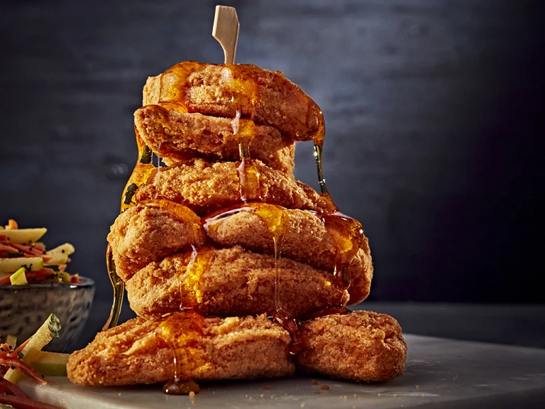 A stack of Quorn Southern Fried Chicken Bites drizzled with maple syrup