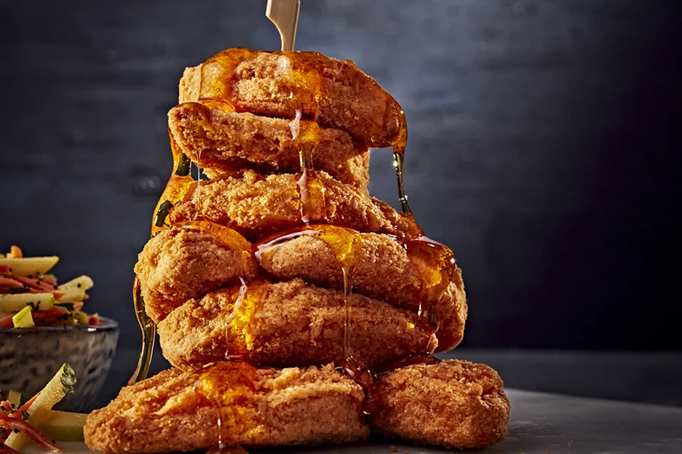 A stack of Quorn Southern Fried Chicken Bites drizzled with maple syrup
