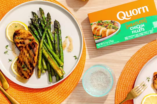 Quorn Vegetarian Fillets with asparagus and a slice of lemon next to Quorn ChiQin fillets packaging.
