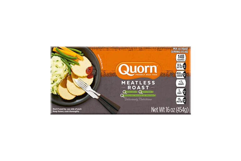 A box of Quorn Meatless Roast showing the product and the product information on an orange and charcoal background.