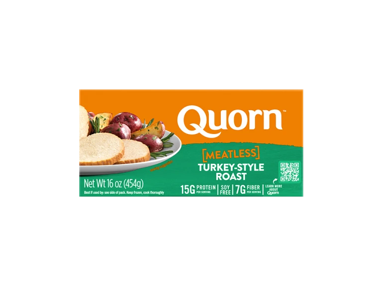 A box of Quorn Meatless Roast showing the product and the product information on an orange and charcoal background.