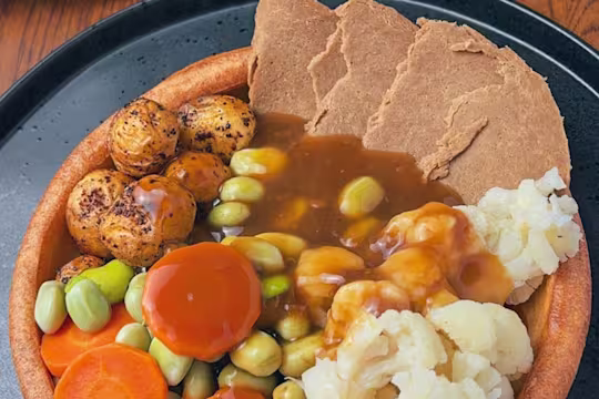 Giant Yorkshire pudding with vegetables and Quorn Roast Beef Style Slices inside
