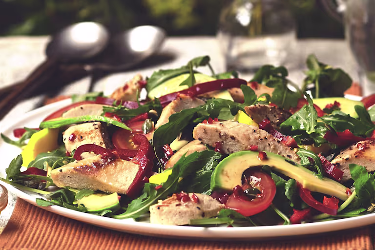 Video still of a Brazilian salad with Quorn Vegetarian fillets, sliced avocado, tomatoes and salad leaves.