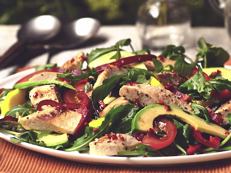 Video still of a Brazilian salad with Quorn Vegetarian fillets, sliced avocado, tomatoes and salad leaves.