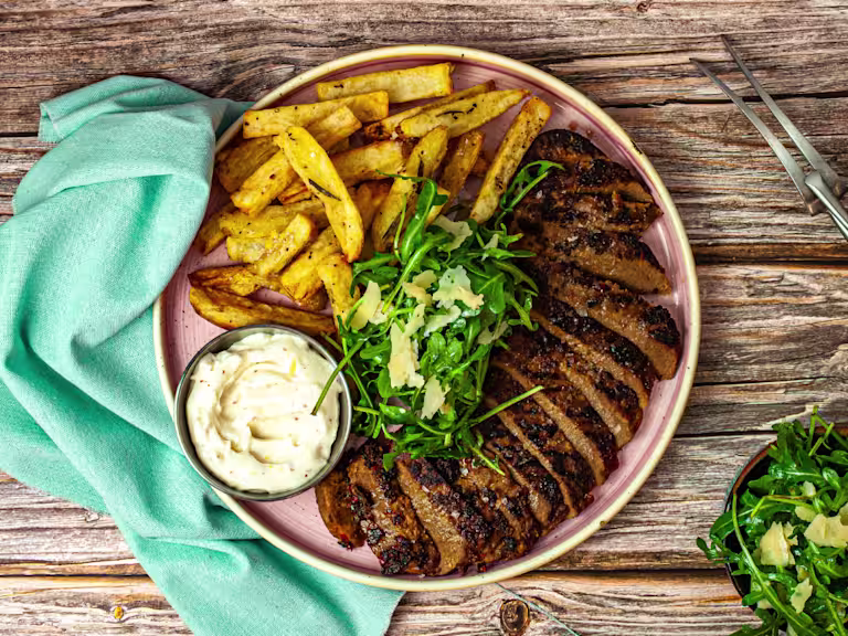 Steak frites with Quorn Vegetarian Peppered Steak, chips and garlic aioli with a garnish of green rocket.