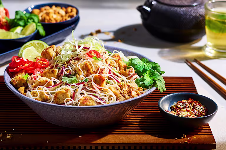 Veggie Pad Thai recipe made with Quorn Pieces and noodles served in a bowl, garnished with chilli and coriander