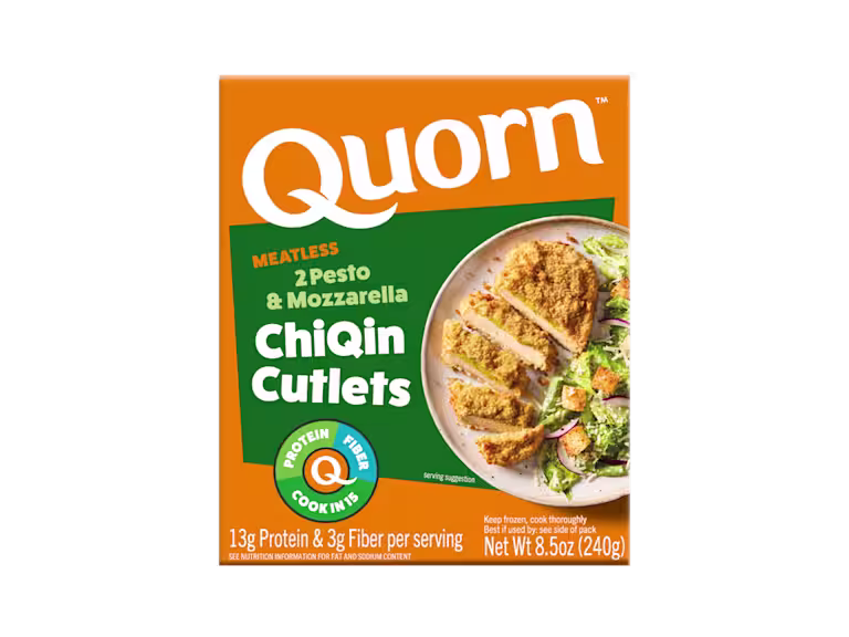 A box of Quorn Meatless Pesto & Mozzarella Cutlets showing the plated product and information on a charcoal and orange background.