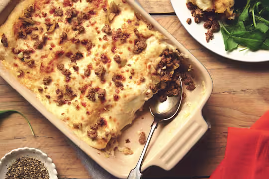 Vegetarian Cannelloni made with meat free Quorn Mince topped with béchamel sauce and scattered mince in a dish