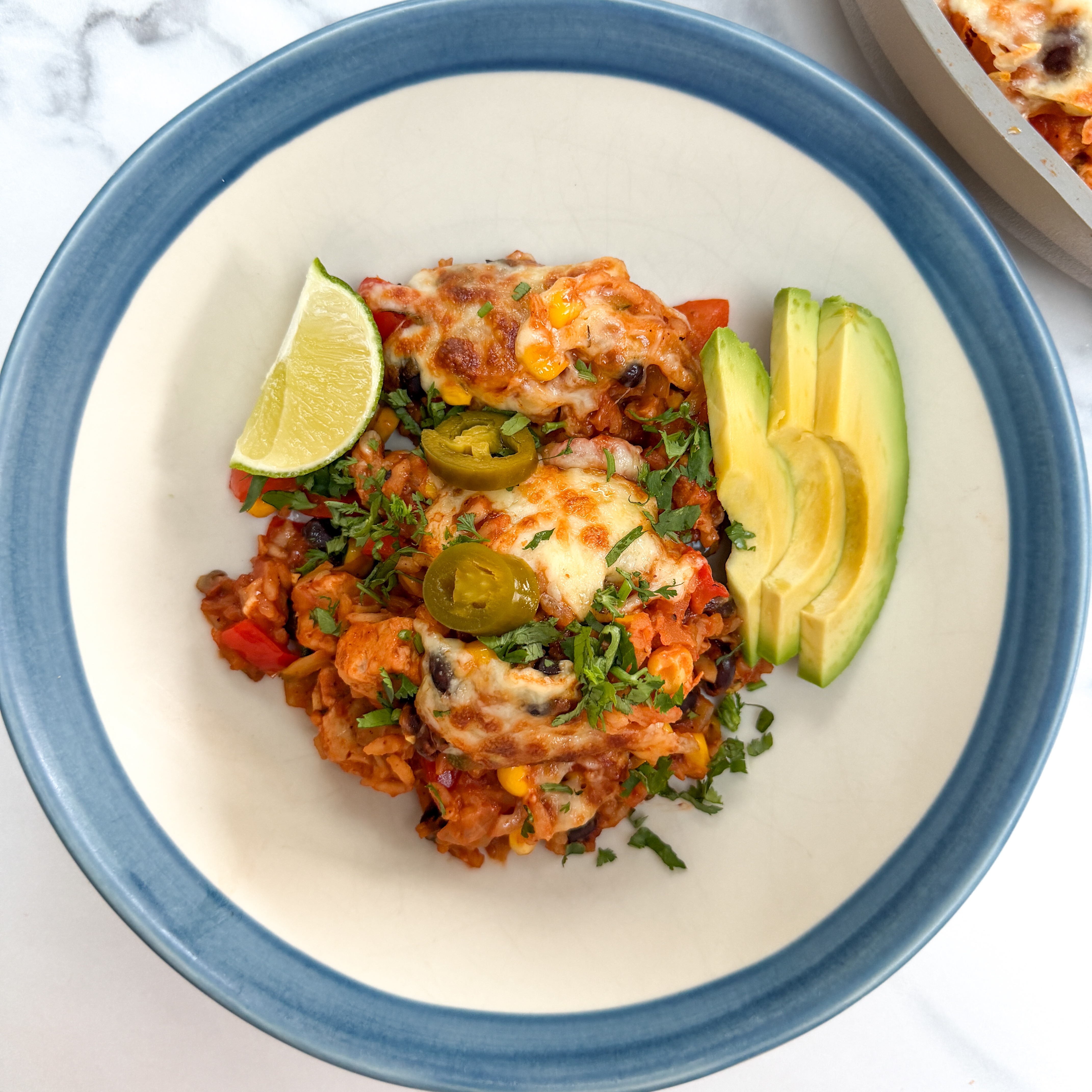 Enchilada and rice one pot recipe with Quorn chilled mince, on a plate with avocado slices and 
