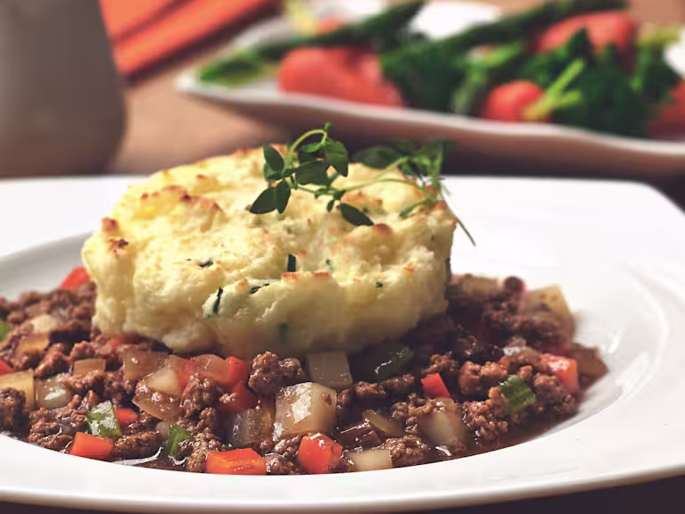 Vegetarian cottage pie deconstructed, made with Quorn Meatless Grounds served in a bowl topped with mash potato and garnish
