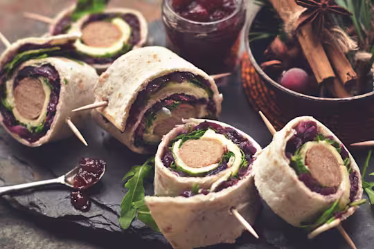 Several Quorn Vegetarian Sausage Wraps with the Quorn Vegetarian Sausage visibile served with cranberry jam.