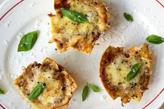 Vegetarian lasagne bites with Quorn Mince, topped with cheese and basil